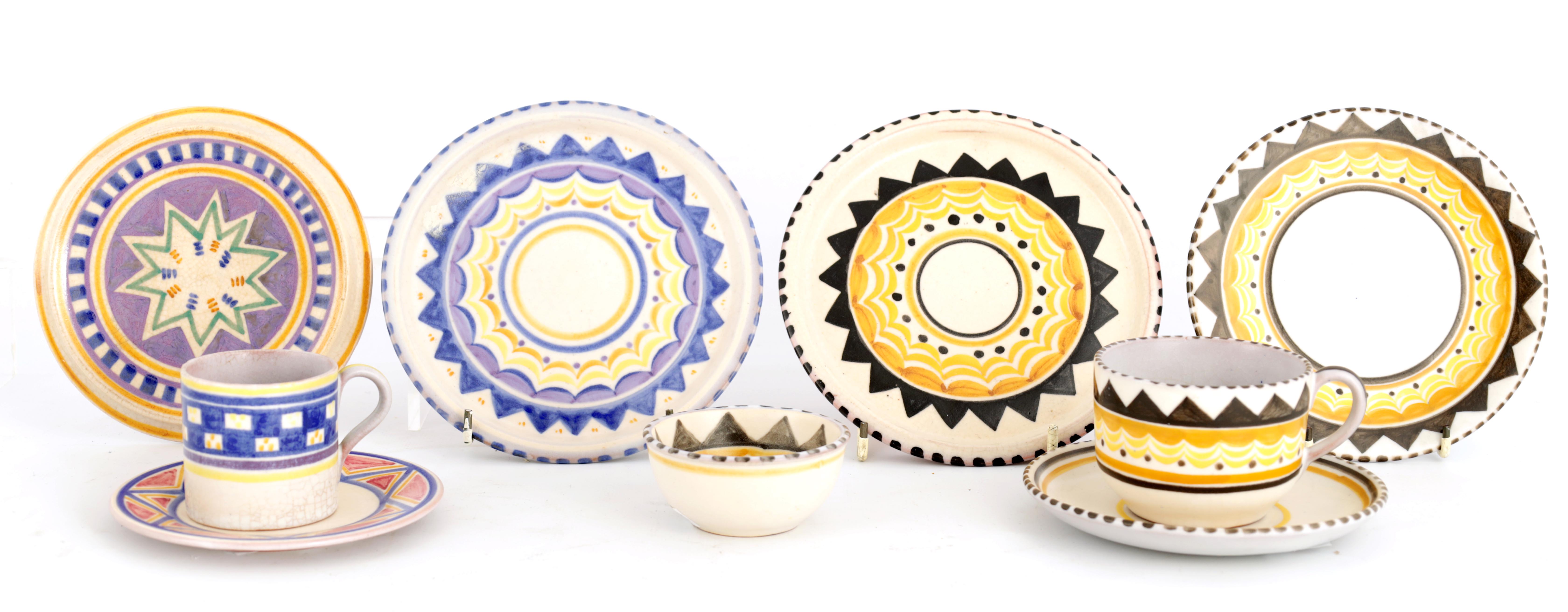 A COLLECTION OF POOLE GEOMETRIC PATTERN TEAWARE including cups, saucers and three teapot stands