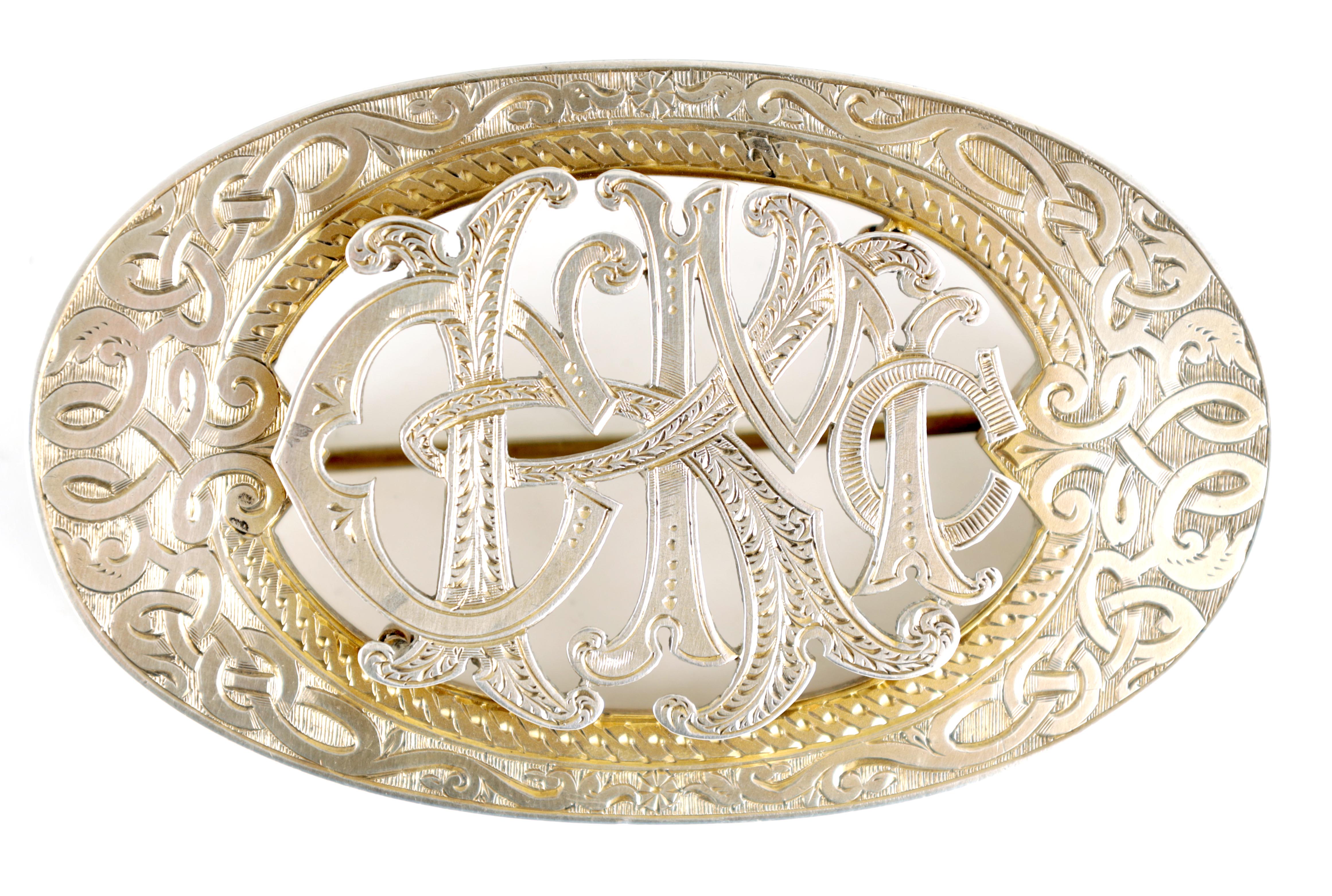 A 19TH CENTURY OVAL SILVER SCOTTISH BROOCH with Celtic design border and entwined initials to the