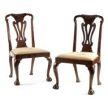 A PAIR OF GEORGE I WALNUT SIDE CHAIRS with leaf carved and scrolled top rails above vase-shaped