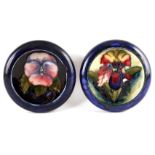 TWO MOORCROFT SHALLOW SMALL DISHES WITH CURVED RIMS decorated with an Orcird flowerhead and Pansy