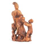 A FINELY CARVED CHINESE SOAPSTONE FIGURE depicting a lady with a child 14cm high