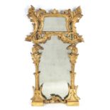 AN 18TH CENTURY CARVED GILTWOOD ROCOCO STYLE HANGING MIRROR with scrolled leaf work decoration