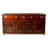 AN 18TH CENTURY OAK DRESSER BASE of superb colour and polish, consisting of three frieze drawers