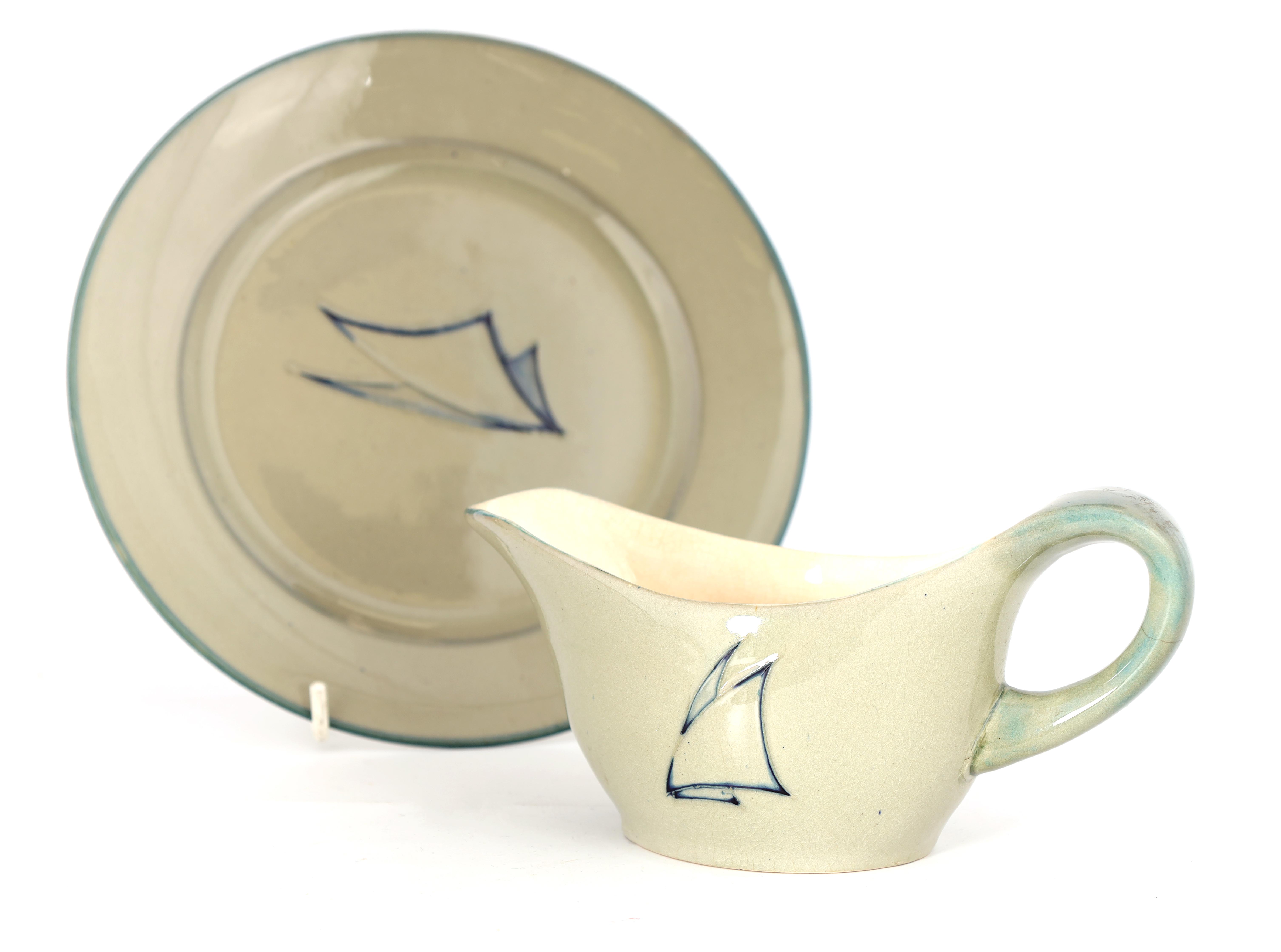 A MOORCROFT PLATE AND MATCHING SAUCE BOAT decorated in the Yacht patern on a celadon ground, 21cm