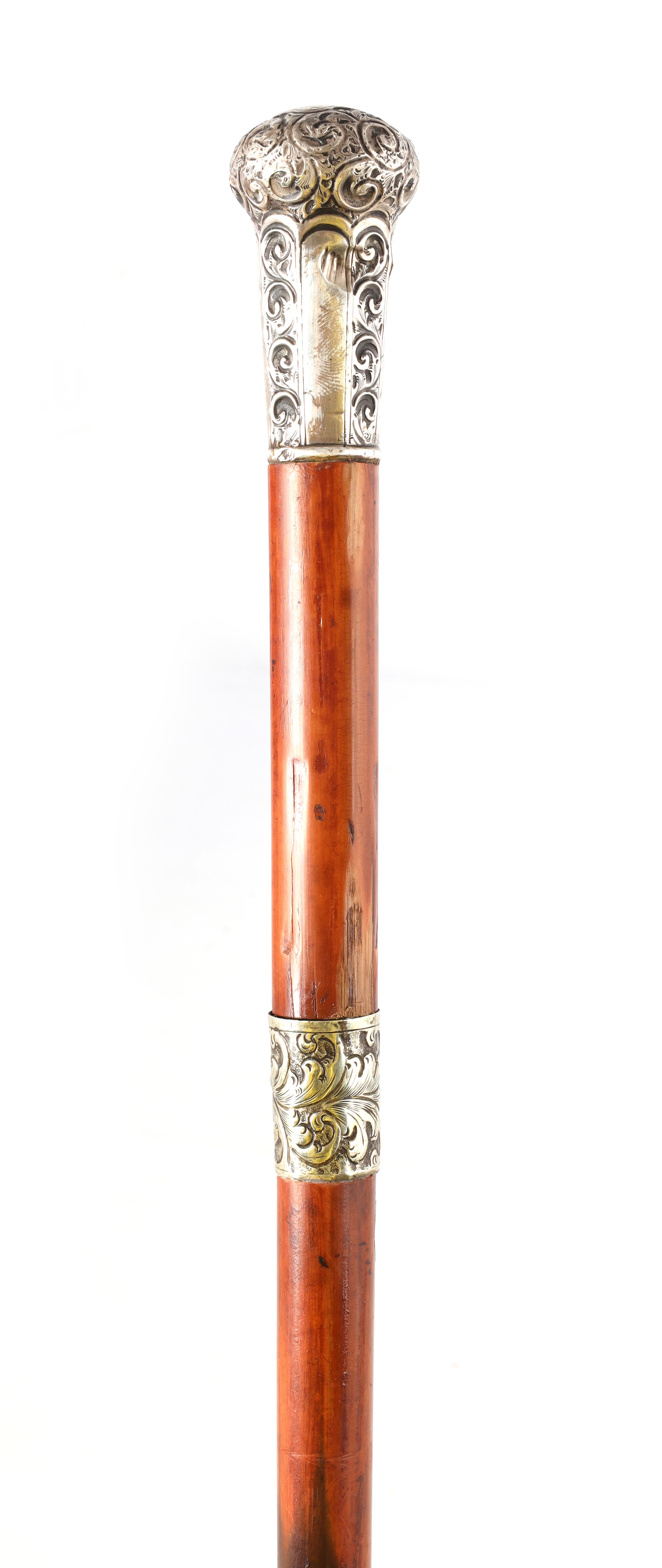 A LATE 19TH CENTURY SILVER TOPPED SWORD STICK with faceted silver pommel and scrollwork decoration