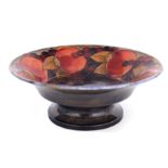 A 1920S WILLIAM MOORCROFT FOOTED FRUIT BOWL WITH EVERTED RIM decorated in the Pomegranate pattern on