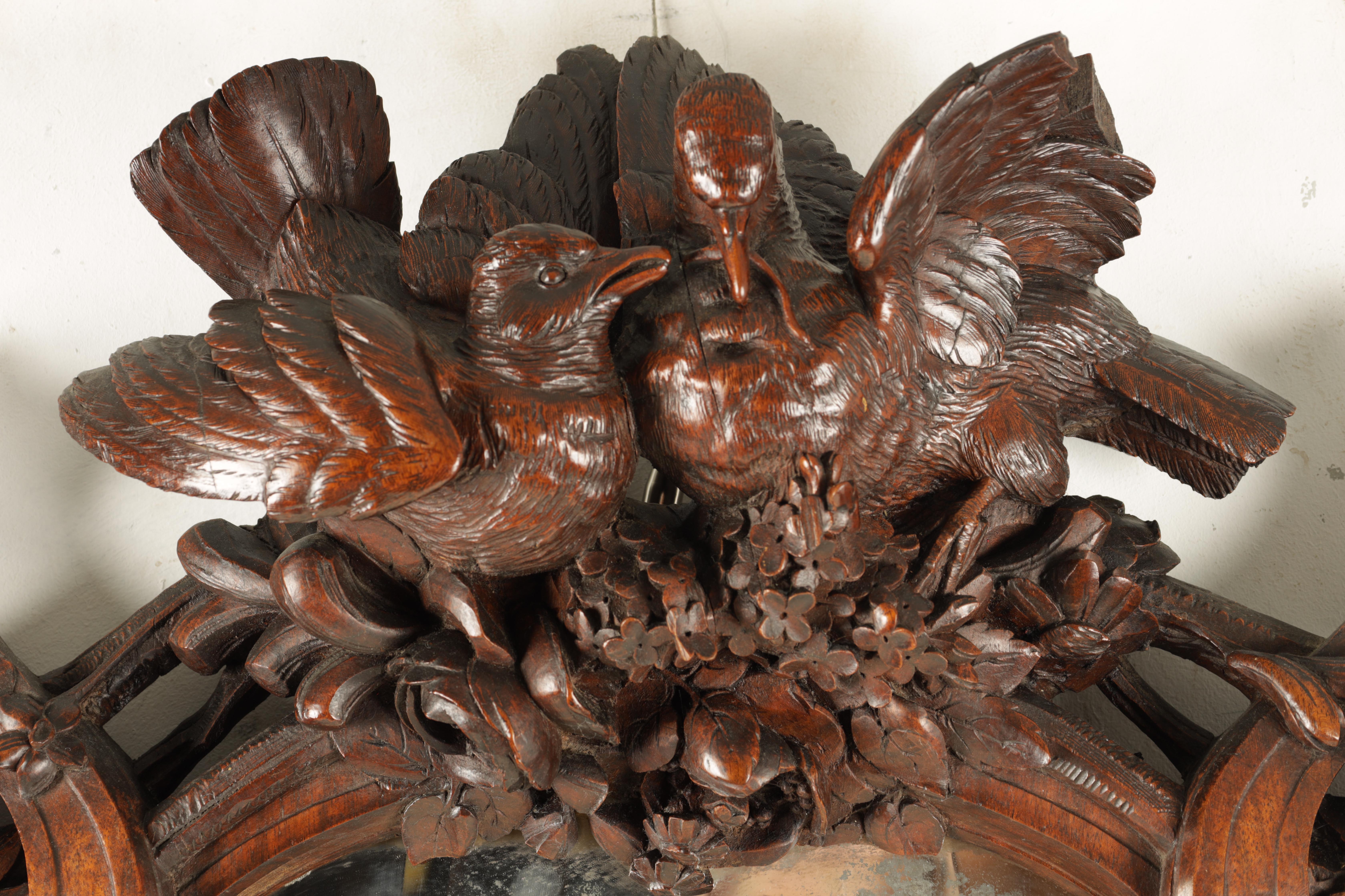 A 19TH CENTURY WALNUT BLACK FOREST CARVED HANGING MIRROR with a pair of doves to the top and a - Image 2 of 5