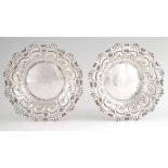 A PAIR OF LATE 19TH CENTURY SILVER SWEETMEAT DISHES with embossed scrollwork decoration and engraved