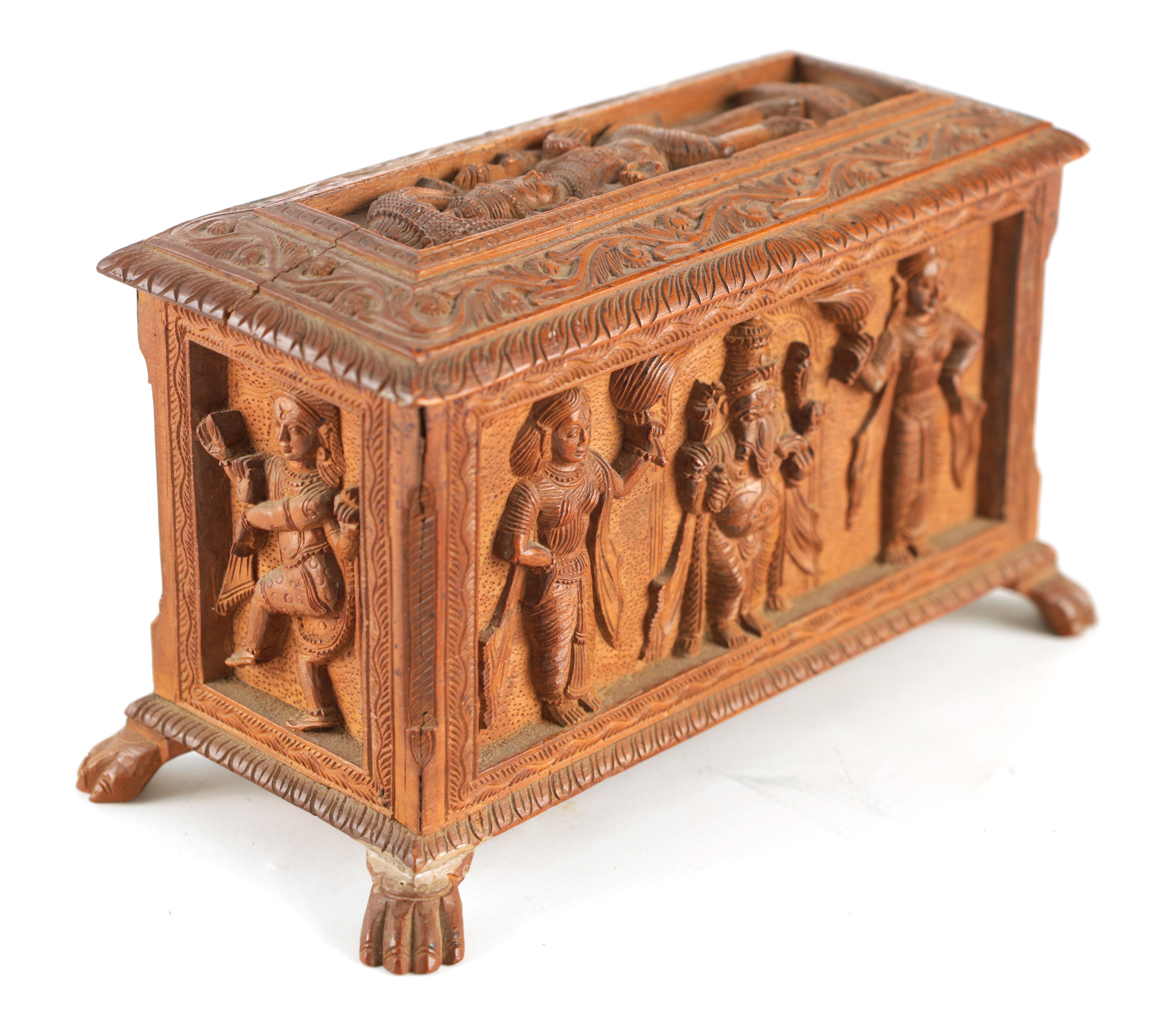 AN EARLY 20TH CENTURY ANGLO-INDIAN CARVED SANDALWOOD BOX with relief carved panels of various Indian