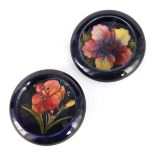 TWO MOORCROFT SHALLOW SMALL DISHES WITH CURVED RIMS decorated with freesia and hibiscus sprays on