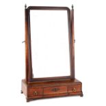 AN EARLY GEORGE III MAHOGANY DRESSING TABLE MIRROR with shaped moulded frame above a base of three