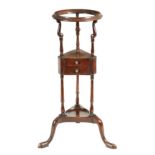 A GEORGE III MAHOGANY WASHSTAND with circular moulded top above a triangular section with two