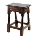 A LATE 17TH CENTURY OAK JOINT STOOL with pegged moulded top above an angled base with ring turned