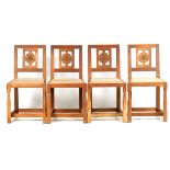 A SET OF FOUR WILF HUTCHINSON (SQUIRELLMAN) OAK DINING CHAIRS the pierced backs carved with