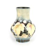 AN UNUSUAL MOORCROFT BULBOUS VASE WITH TALL NECK tube lined and decorated with a version of the Leaf