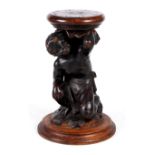 A 19TH CENTURY WALNUT REVOLVING BLACKAMOOR STOOL with circular adjustable top above a crouching