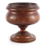 A LARGE AND HEAVY 19TH CENTURY TURNED WALNUT MORTAR of baluster shape with heavy moulded rim and