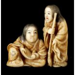 A JAPANESE MEIJI PERIOD CARVED IVORY AND ENGRAVED NETSUKE modelled as two street entertainers 3.