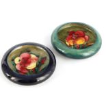 TWO MOORCROFT SHALLOW SMALL DISHES WITH CURVED RIMS decorated with Orchid sprays on dark mottled