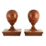 A PAIR OF 19TH CENTURY SPHERICAL SHAPED HONEY COLOURED OAK NEWEL POSTS mounted on square pagoda