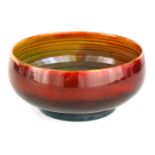 AN UNUSUAL MOORCROFT SMALL FOOTED BOWL with flambe ground with a ribbed multicoloured centre, 14.5cm