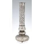 A 19TH CENTURY EASTERN SILVER PIERCED VASE with long neck and squat bulbous base standing on small