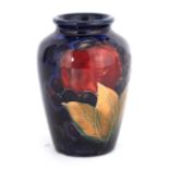 A 1930S MOORCROFT SMALL SHOULDERED OVOID VASE decorated in the Pomegranate pattern on a dark mottled