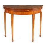 AN EDWARDIAN INLAID MAHOGANY SHERATON STYLE DEMI LUNE CARD TABLE with fanned segmented top revealing