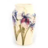 A MOORCROFT SMALL TAPERING SHOULDERED VASE decorated with orchid sprays on a cream ground, 13cm