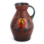 A MOORCROFT OVOID TAPERING JUG WITH OGEE NECK decorated with sprays of Autumn Leaves and Berries