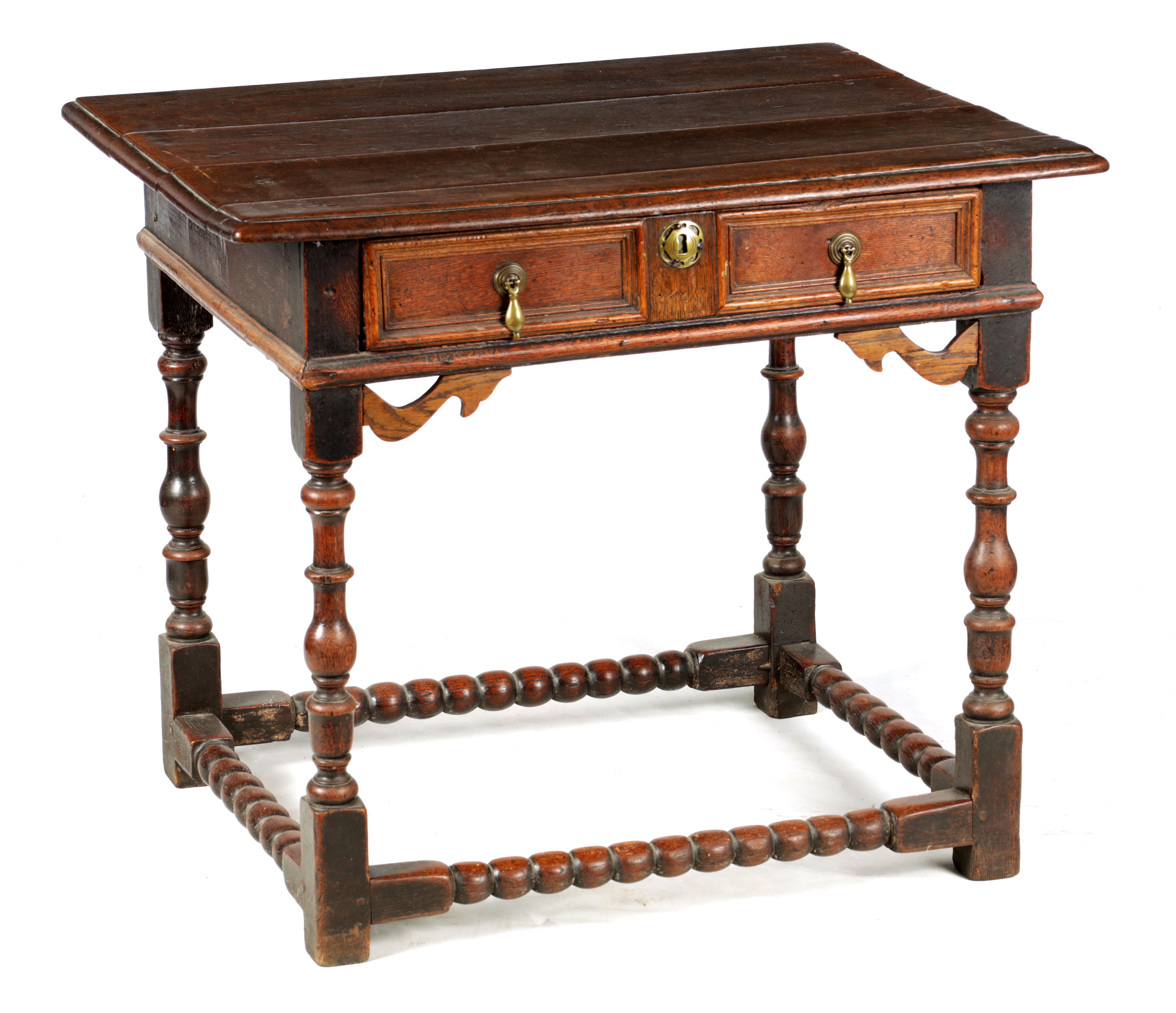 A 17TH CENTURY JOINED OAK SIDE TABLE with panelled frieze drawer and shaped pierced corner blocks;