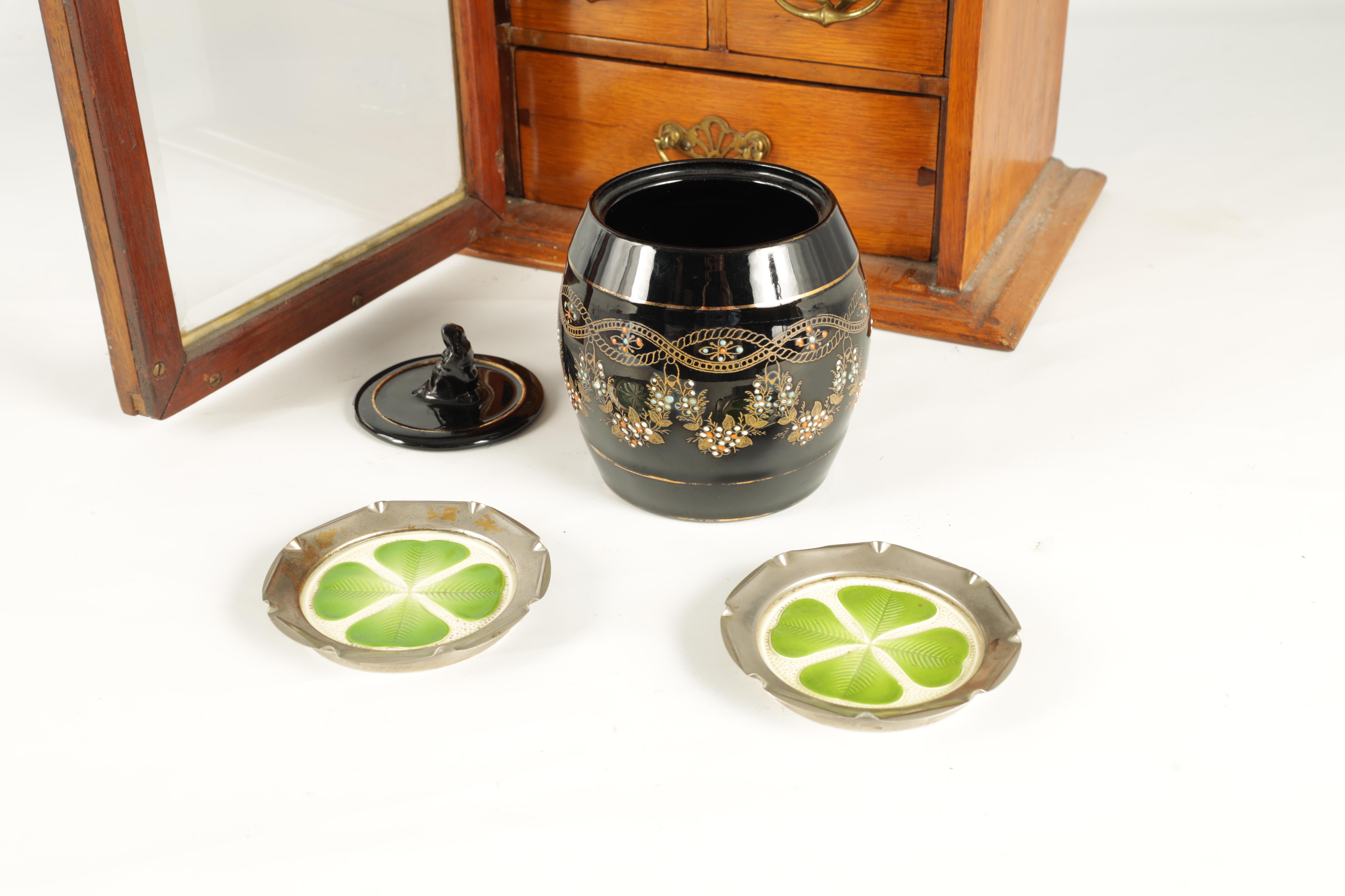 A STYLISH EDWARDIAN OAK SMOKERS CABINET with glazed door enclosing a shelved three drawer interior - Image 9 of 11