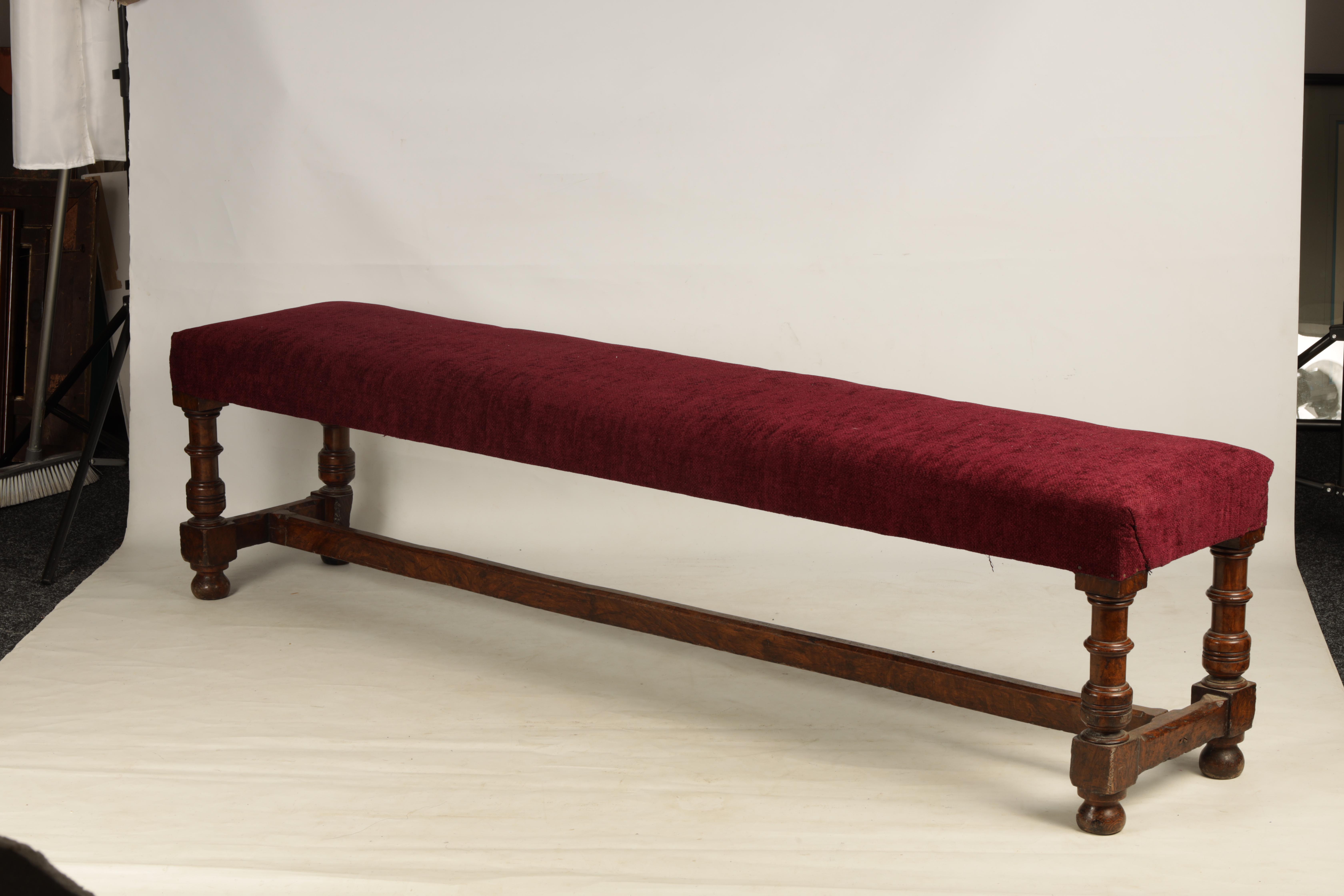 A 19TH CENTURY WALNUT WINDOW SEAT with upholstered top; standing on ring turned legs joined by a H - Image 2 of 7