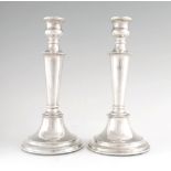 A PAIR OF MID 20TH CENTURY SILVER CANDLESTICKS having beaded edge decoration and circular bases 22.