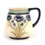 AN EARLY MACINTYRE BURSLEM LARGE JUG WITH ROUNDED TAPERING BODY decorated with sprays of blue