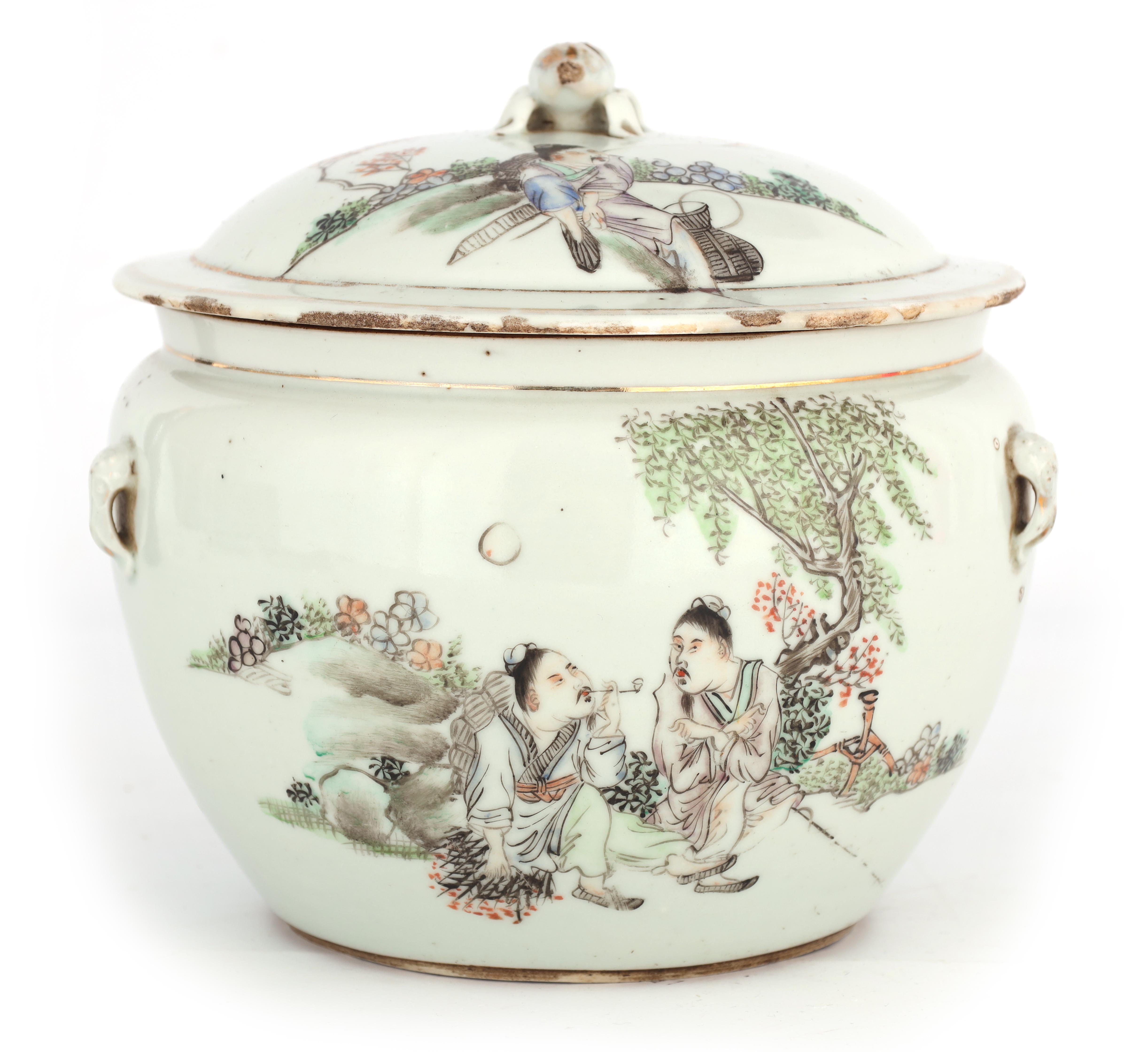 AN 18TH CENTURY CHINESE PORCELAIN FOOD JAR AND COVER decorated with figures in a tree lined