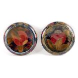 TWO EARLY WILLIAM MOORCROFT CIRCULAR SHALLOW DISHES WITH CURVED RIMS decorated all over in the