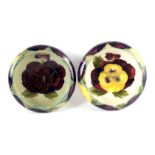 TWO MOORCROFT SHALLOW SMALL DISHES WITH CURVED RIMS both decorated in the Pansy pattern on neutral