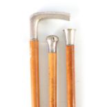 A COLLECTION OF THREE SILVER TOPPED MALACCA WALKING STICKS of various designs, longest 91cm