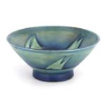 A MOORCROFT FOOTED FLARED BOWL decorated in shades of blue in the Yacht pattern, with a salt glaze