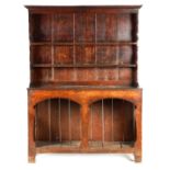 AN EARLY 18TH CENTURY SILHOUETTE LEG OAK DRESSER AND RACK with shaped moulded rack fitted two