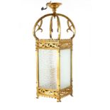 AN EARLY 20TH CENTURY LACQUERED BRASS HALL LANTERN having cabriolet shaped supports with leaf work