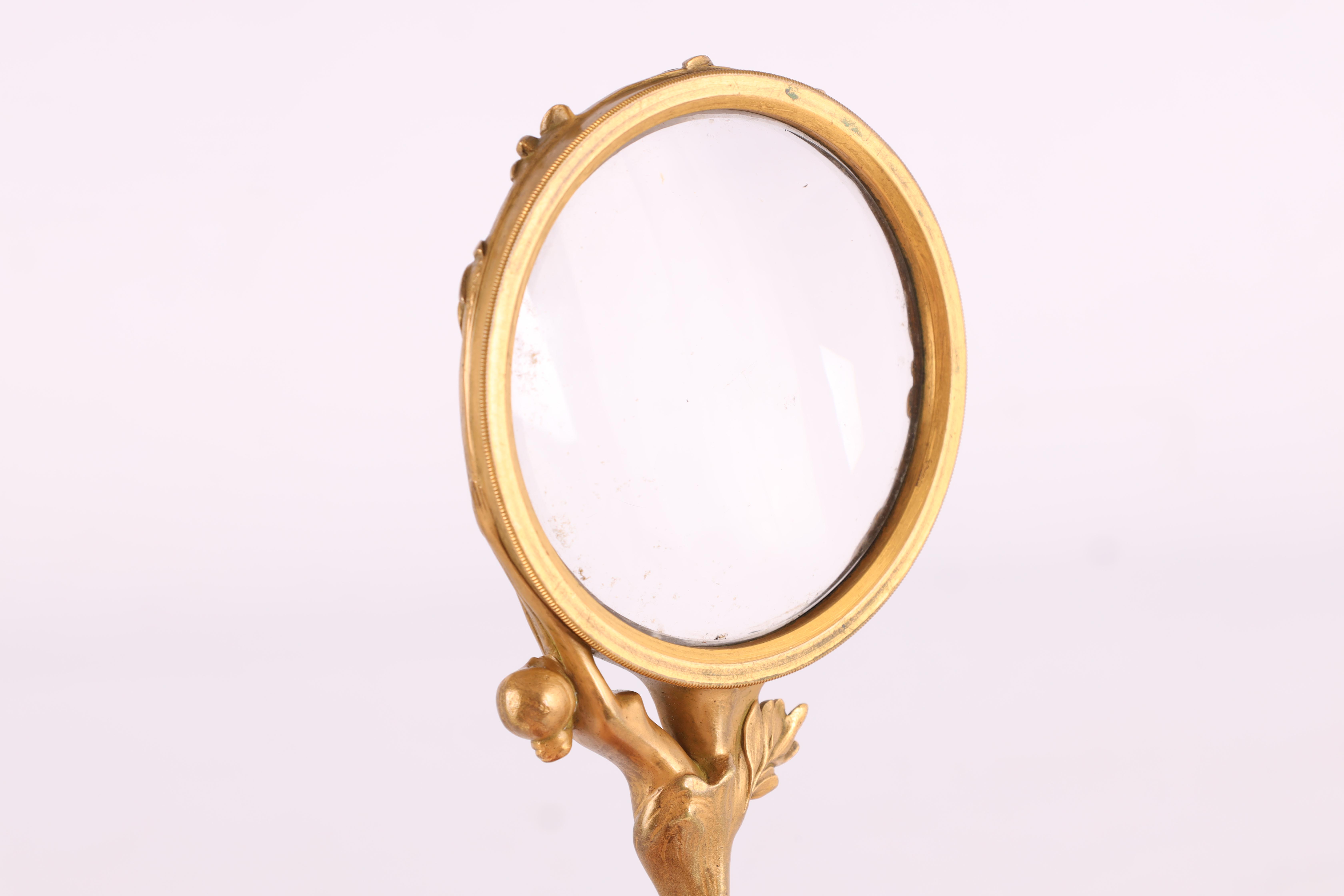 A FRENCH GILT BRONZE ART NOUVEAU MAGNIFYING GLASS the handle decorated with a stylized nude female - Image 4 of 4