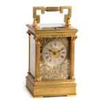 A LATE 19TH CENTURY FRENCH BRASS AND FILIGREE PANELLED REPEATING CARRIAGE CLOCK the case with reeded