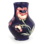 A MOORCROFT BULBOUS VASE WITH SLENDER NECK tube lined and decorated with the Poppy design on a