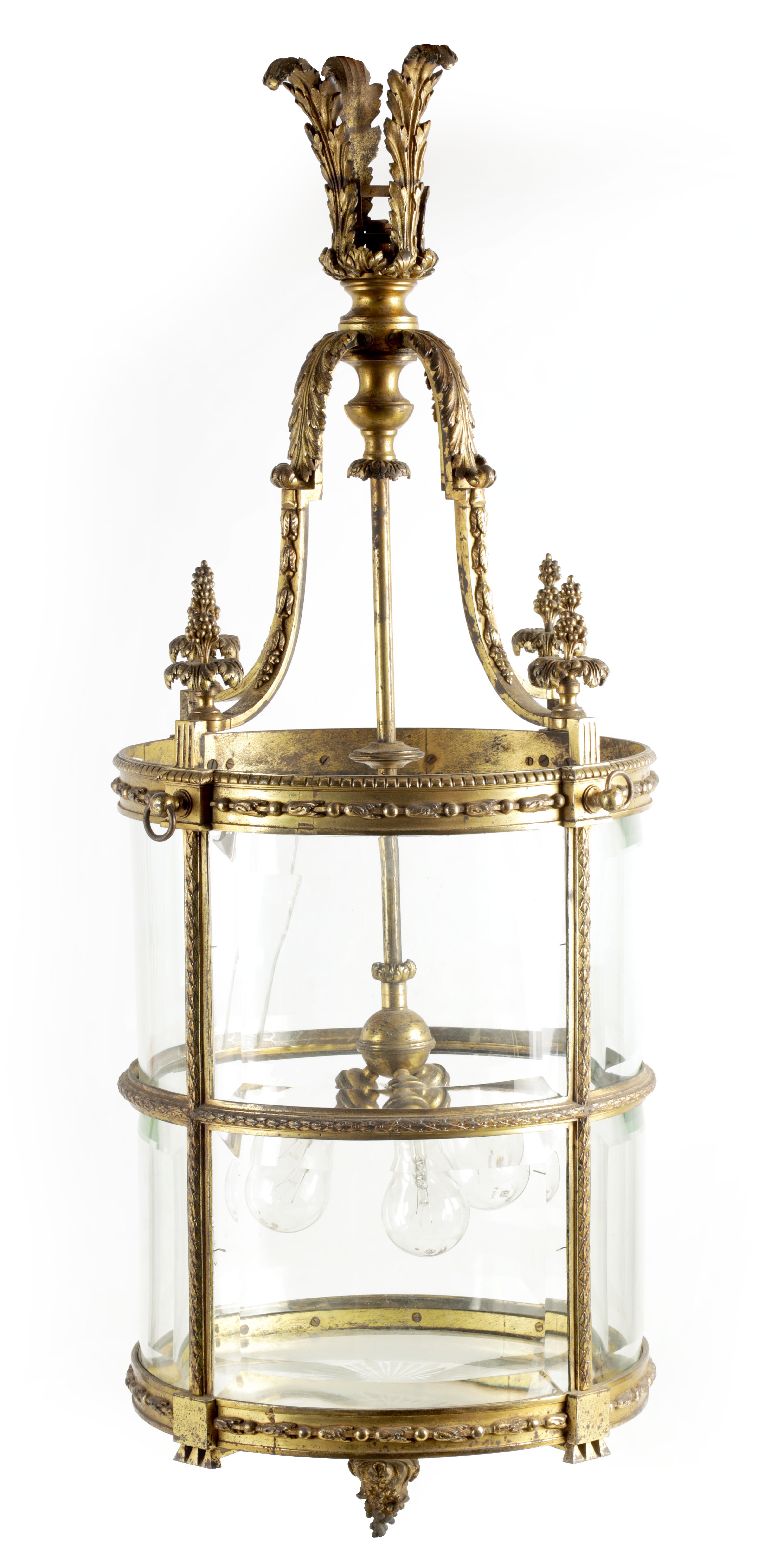 A LARGE REGENCY GILT BRASS HANGING LANTERN with leaf cast circular frame fitted with bevelled