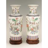 A FINE PAIR OF 19TH CENTURY CHINESE FAMILLE ROSE ENAMELED PORCELAIN VASES of cylindrical tapering