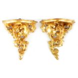 A PAIR OF 19TH CENTURY ITALIAN FLORENTINE GILT WOOD HANGING BRACKETS of ornate scrolled leaf work