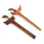 TWO LATE 19TH CENTURY INDONESIAN KRIS DAGGERS one with walnut and brass mounted scabbard and