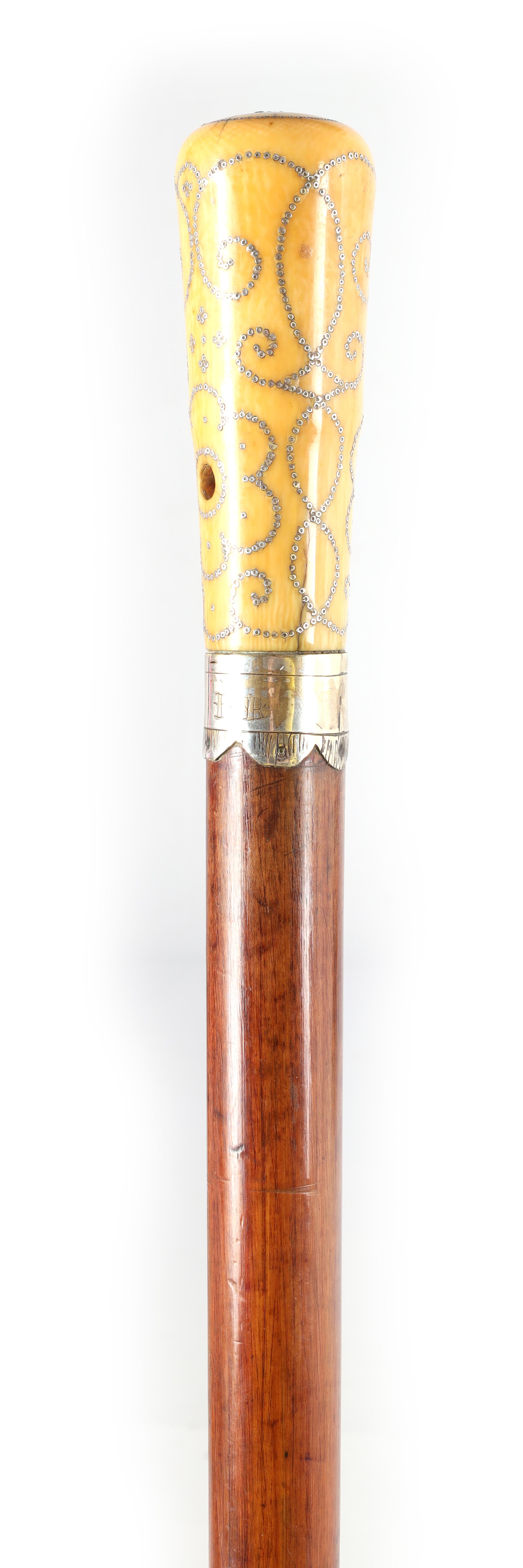 A LATE 17TH CENTURY IVORY AND PIQUE WORK MALACCA WALKING STICK the handle with silver inlaid